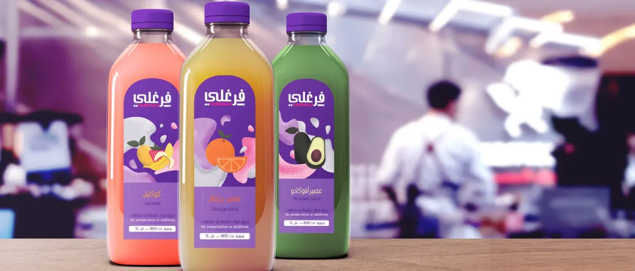 Three Farghali juice bottles on a counter in front of a busy juice bar