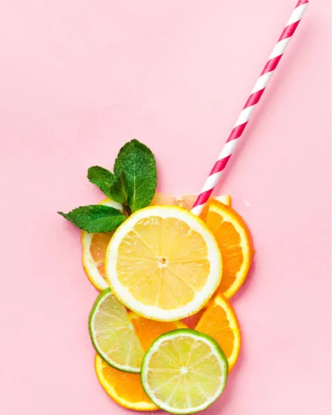 Citrus slices arranged as a glass with a striped straw