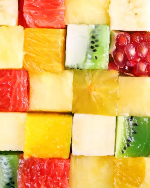 Colorful cubes of fresh fruit including watermelon, pineapple, kiwi and pomegranate