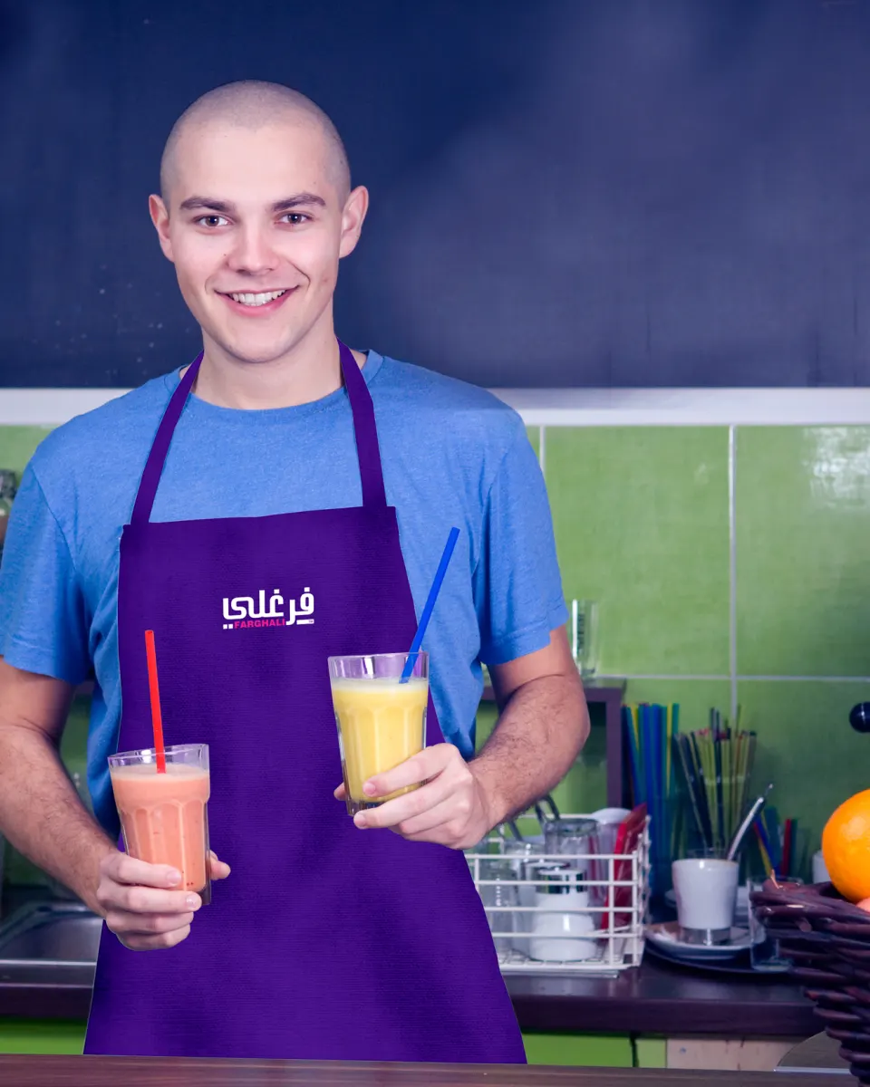 A smiling Farghali team member in a branded apron holding two fresh juices